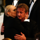 Illustration for article titled Charlize Theron Kisses Journalist Sean Penn